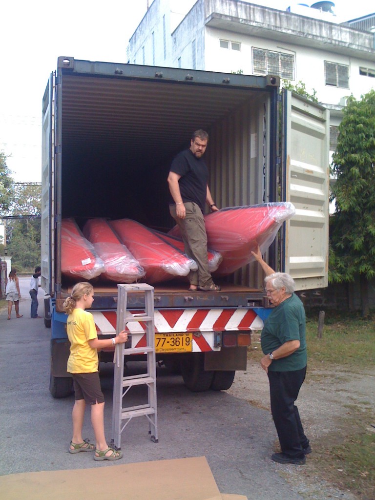 Nong Miriam, Ajaan Mark, and Paw Chuck starting to unload.